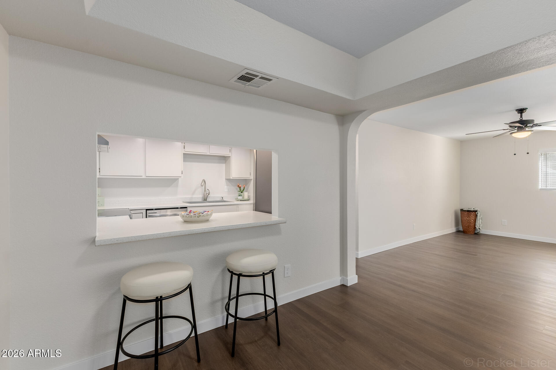 214 East Ruth Avenue, Unit 103 Phoenix, AZ 85020 - Photo 13 of 23 a kitchen with kitchen island a stove a table and chairs in it