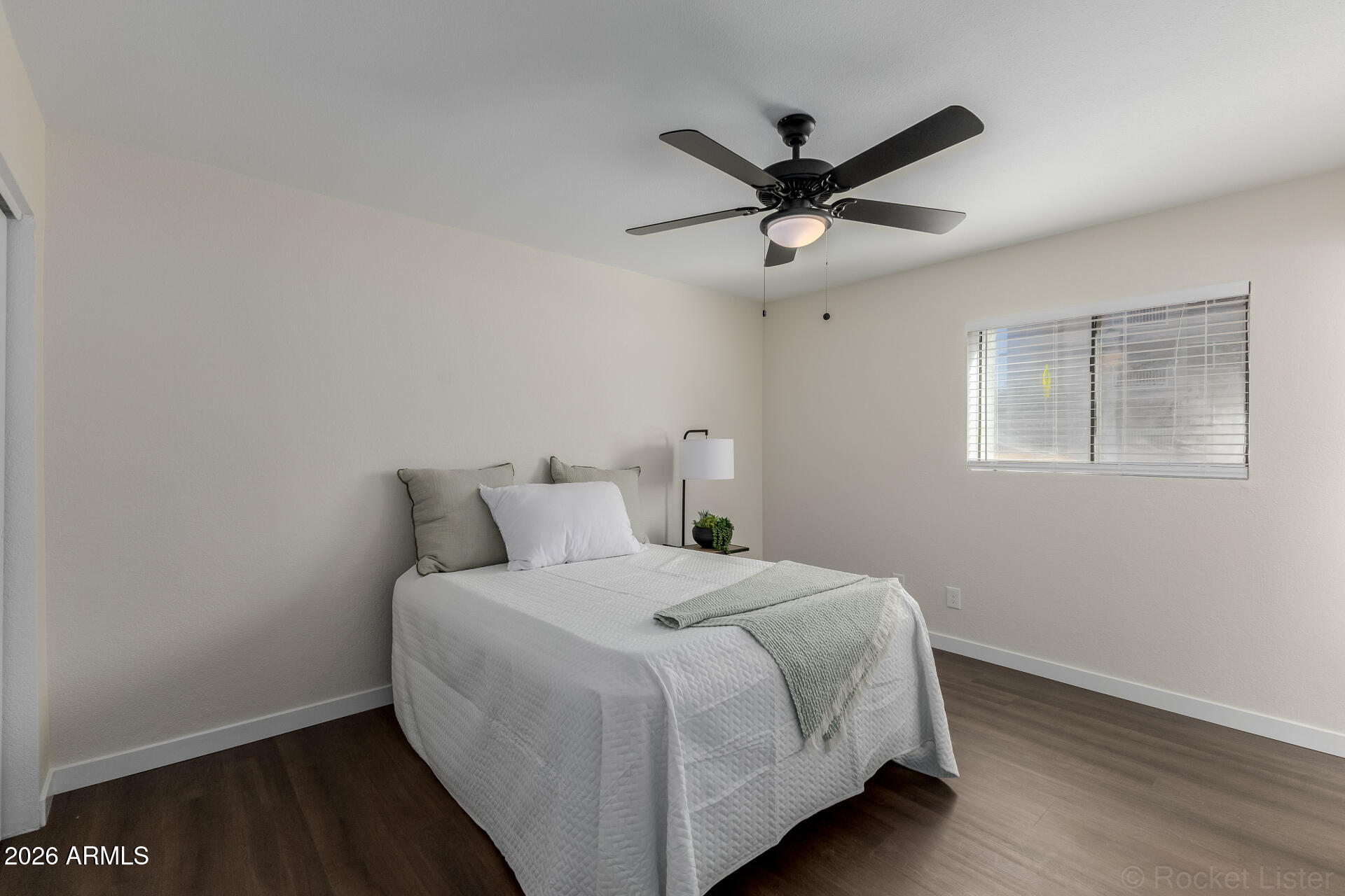 214 East Ruth Avenue, Unit 103 Phoenix, AZ 85020 - Photo 14 of 23 a bedroom with a bed and wooden floor