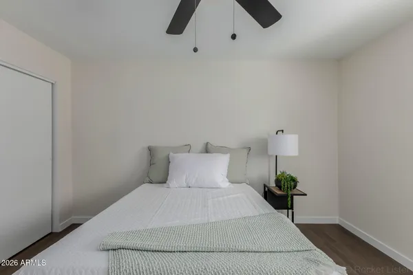 a bedroom with a bed and a chandelier fan