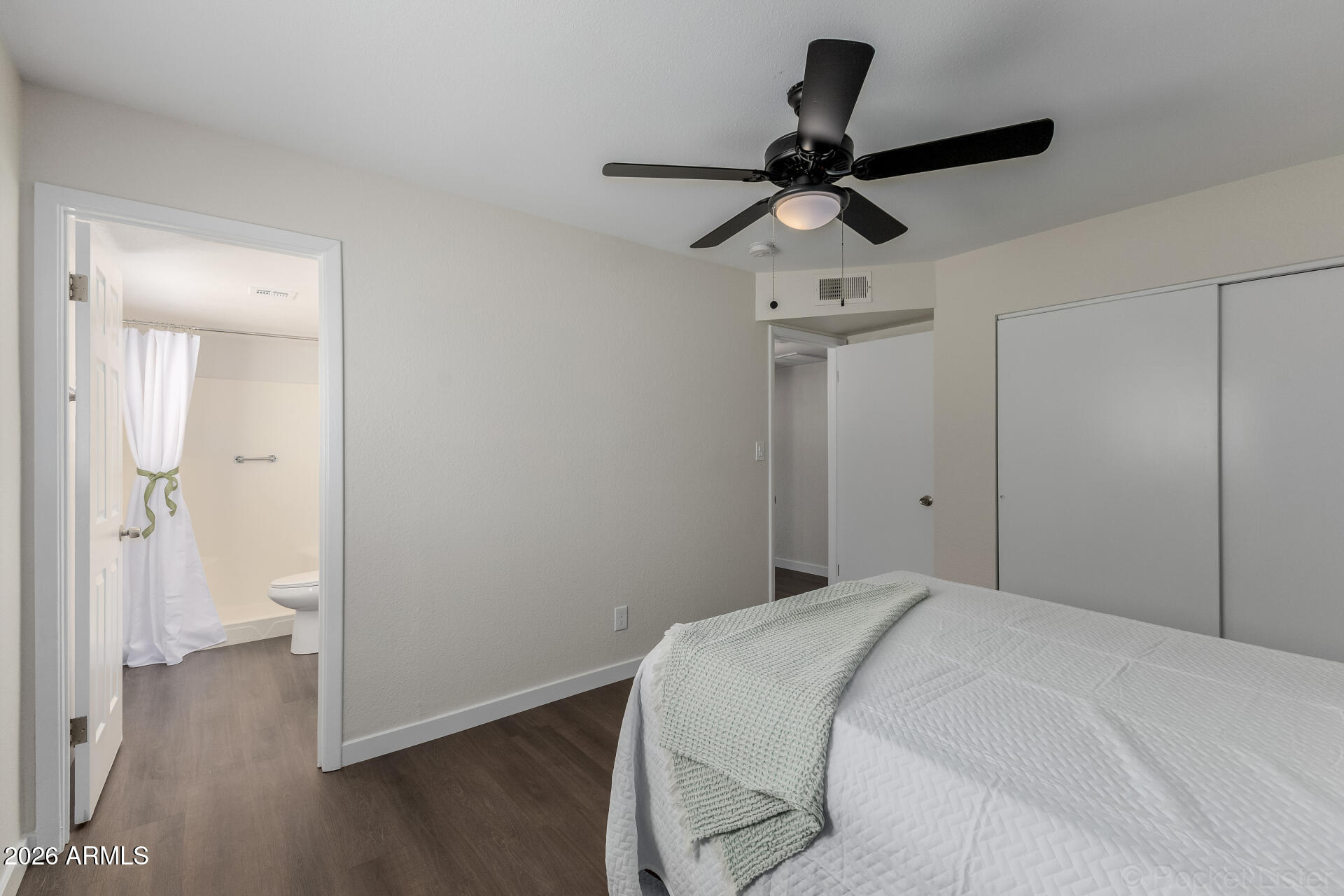 214 East Ruth Avenue, Unit 103 Phoenix, AZ 85020 - Photo 16 of 23 a bedroom with a bed and a chandelier fan