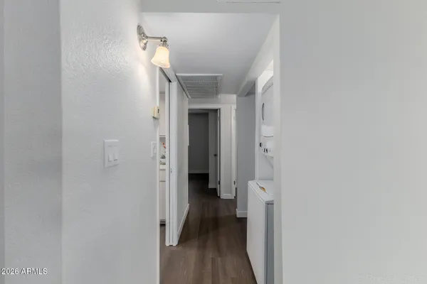 a view of washer and dryer with wooden floor