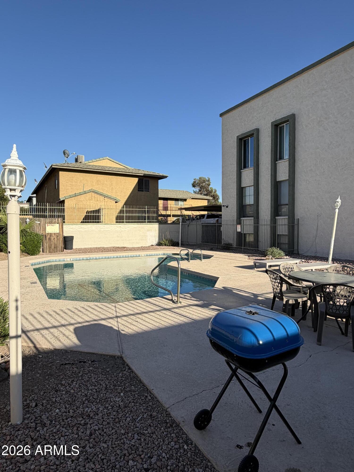 214 East Ruth Avenue, Unit 103 Phoenix, AZ 85020 - Photo 23 of 23 a backyard of a house with table and chairs