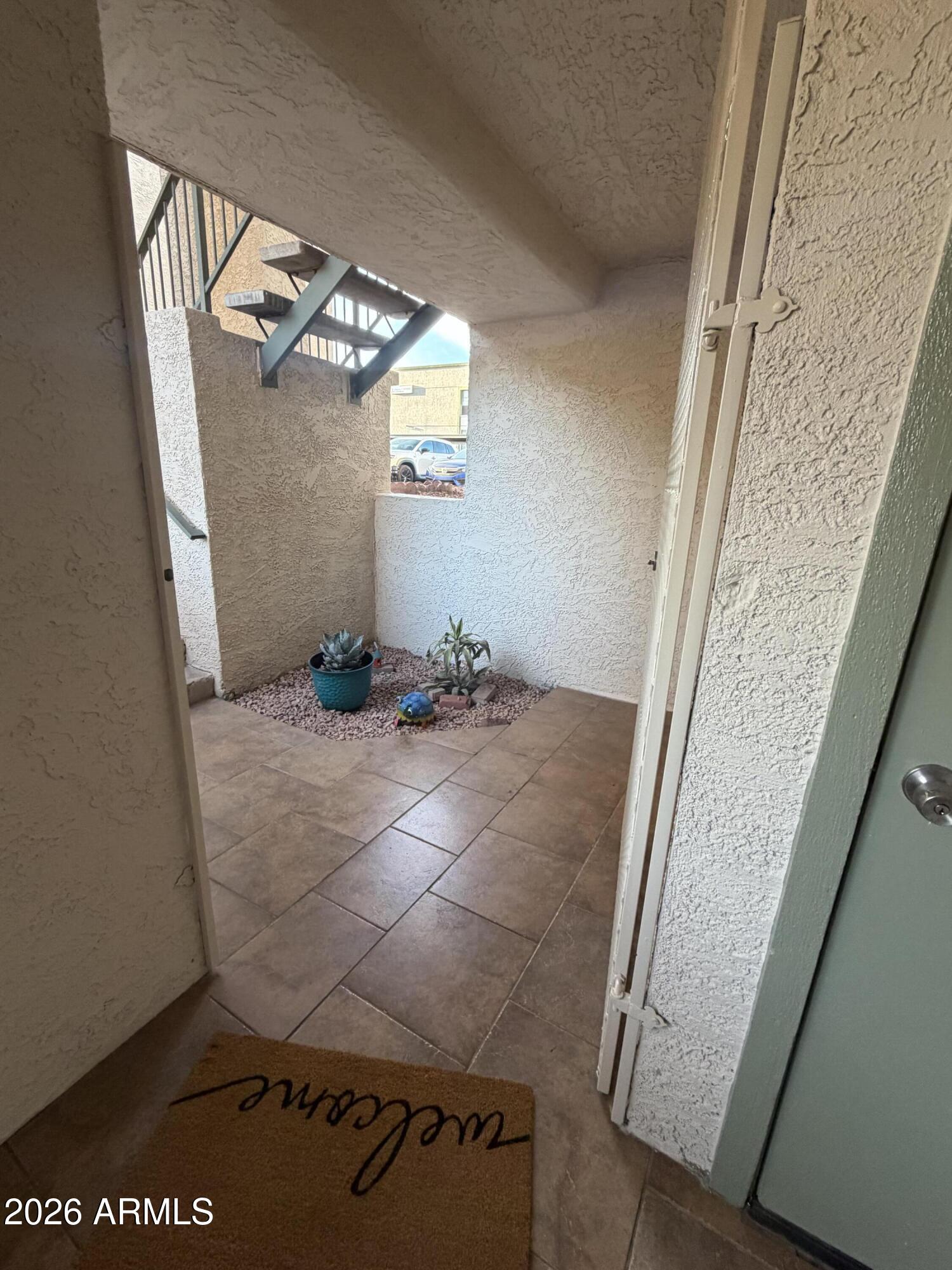 214 East Ruth Avenue, Unit 103 Phoenix, AZ 85020 - Photo 3 of 23 a view of a livingroom with wooden floor and stairs