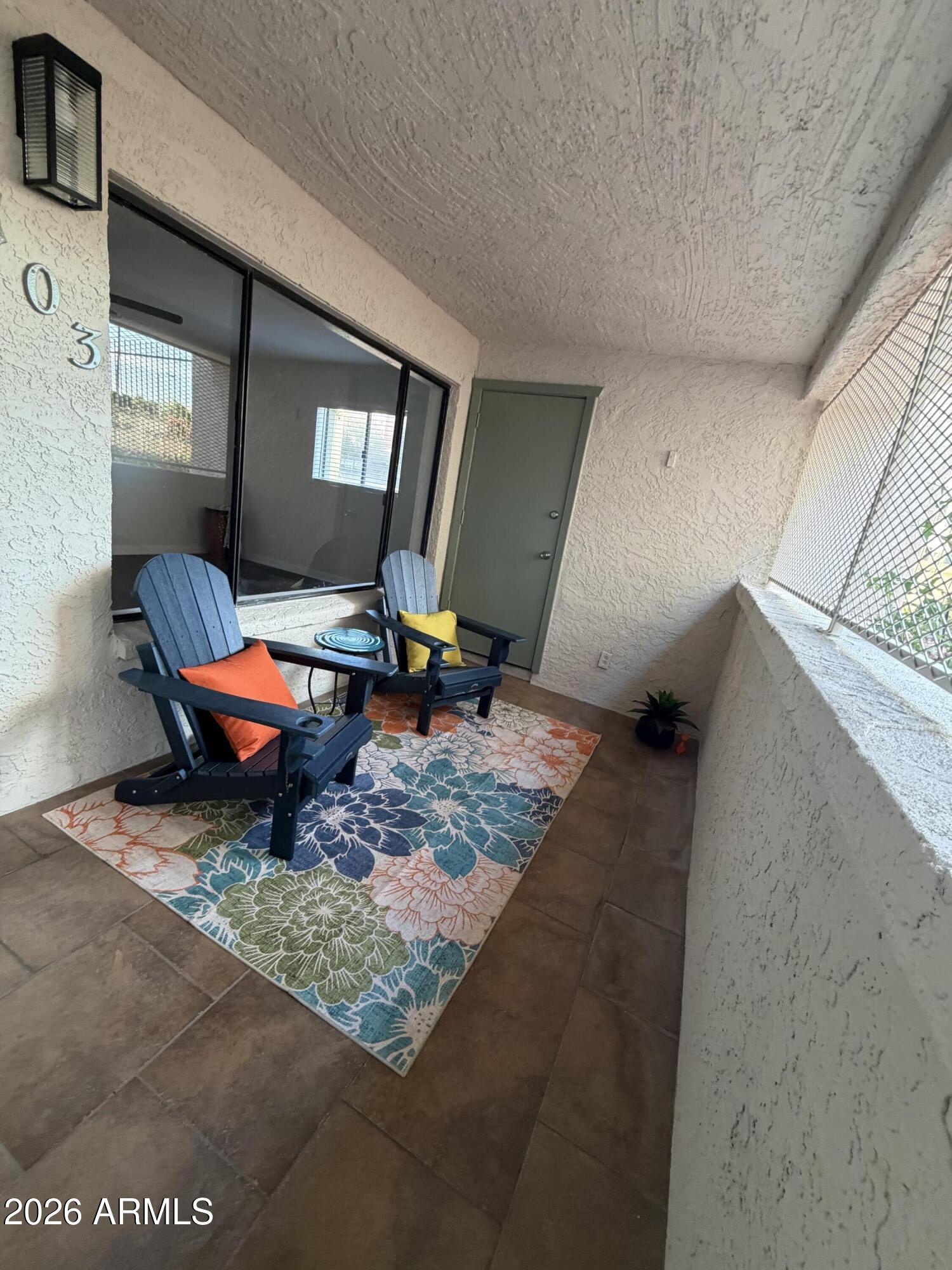 214 East Ruth Avenue, Unit 103 Phoenix, AZ 85020 - Photo 6 of 23 a living room with furniture and a rug