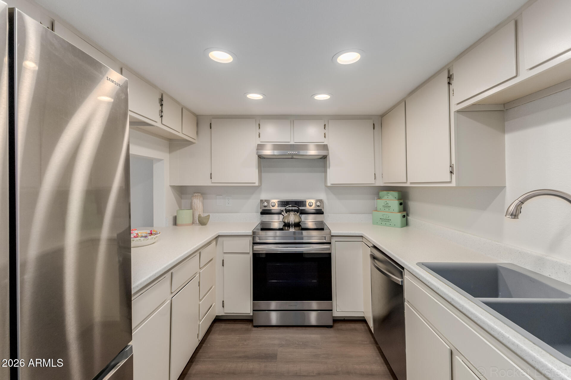 214 East Ruth Avenue, Unit 103 Phoenix, AZ 85020 - Photo 10 of 23 a kitchen with stainless steel appliances granite countertop a sink stove and refrigerator