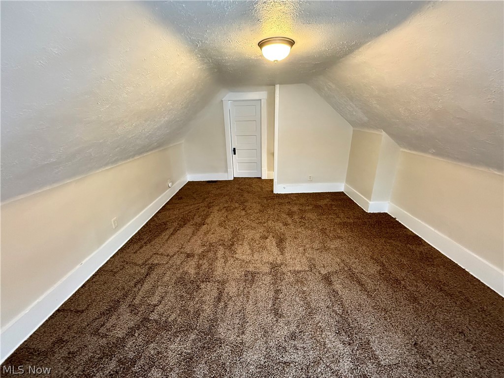 39 North Balch Street Akron, OH 44303 - Photo 5 of 19 Bonus room with a textured ceiling and dark carpet