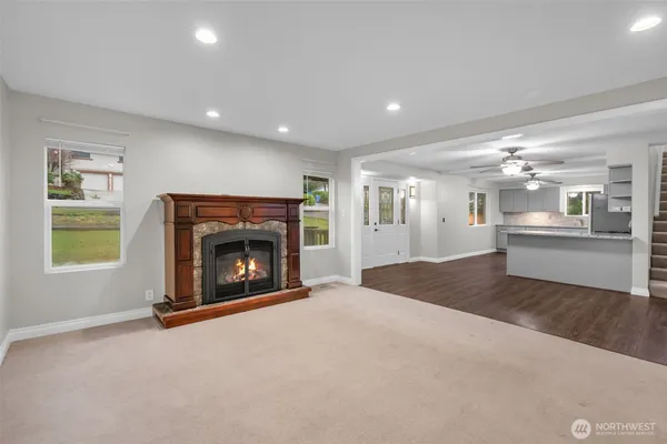 a view of an empty room with a fireplace and a window
