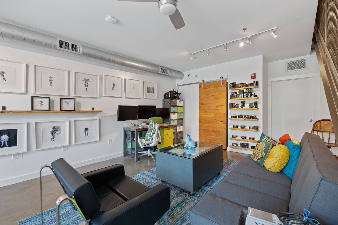 1601 East Cesar Chavez Street, Unit 104 Austin, TX 78702 - Photo 2 of 33 a living room with patio furniture and a flat screen tv