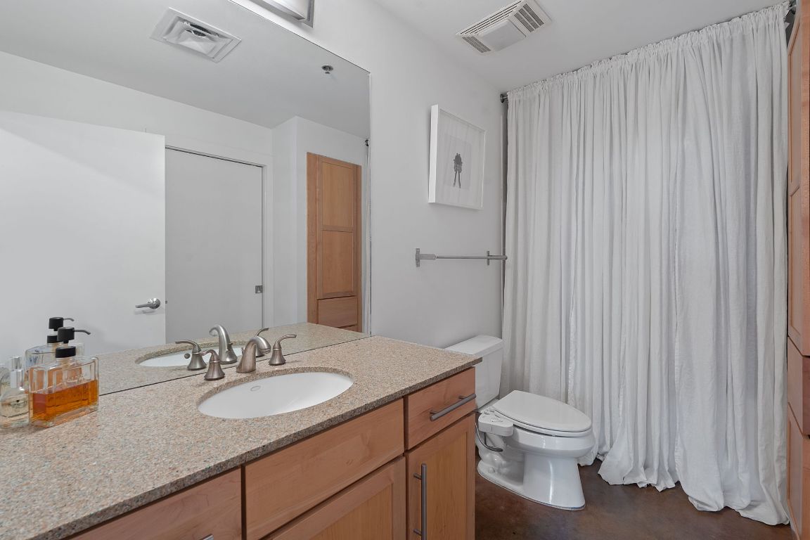 1601 East Cesar Chavez Street, Unit 104 Austin, TX 78702 - Photo 20 of 33 a bathroom with a sink toilet and shower