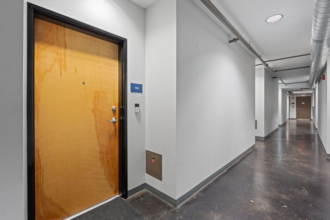 1601 East Cesar Chavez Street, Unit 104 Austin, TX 78702 - Photo 24 of 33 a view of a hallway with wooden floor and a window