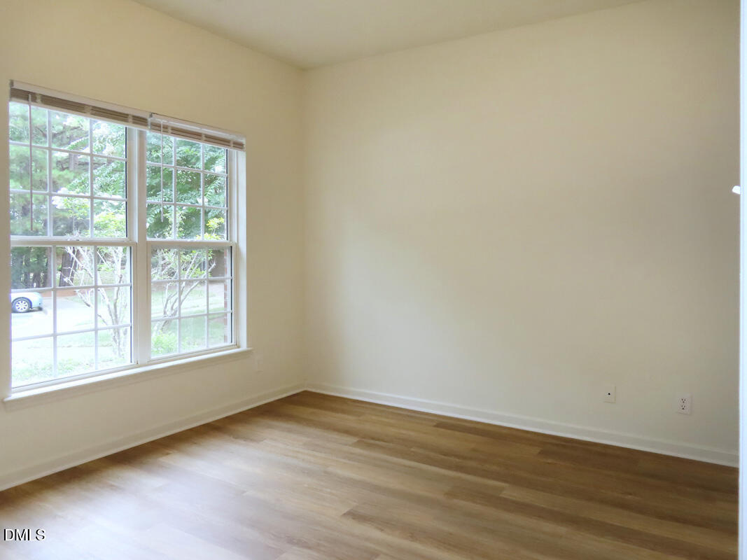 101 Rock Haven Road, Unit E500 Carrboro, NC 27510 - Photo 11 of 19 an empty room with wooden floor and windows