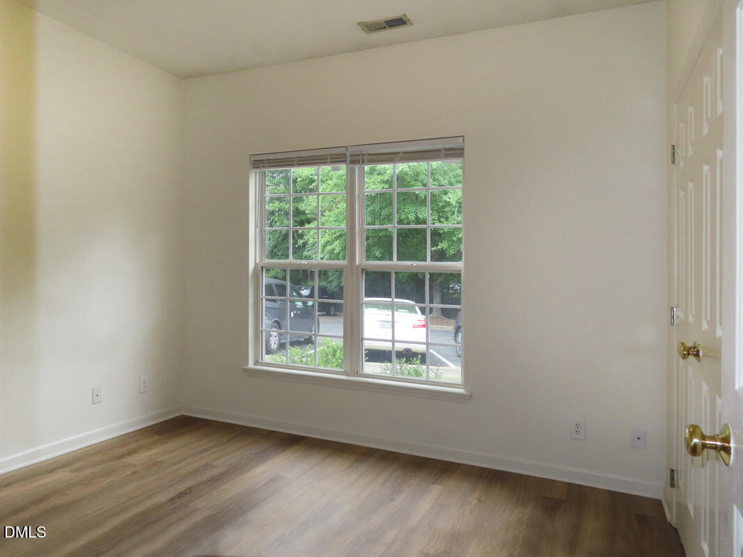 101 Rock Haven Road, Unit E500 Carrboro, NC 27510 - Photo 12 of 19 an empty room with wooden floor and windows