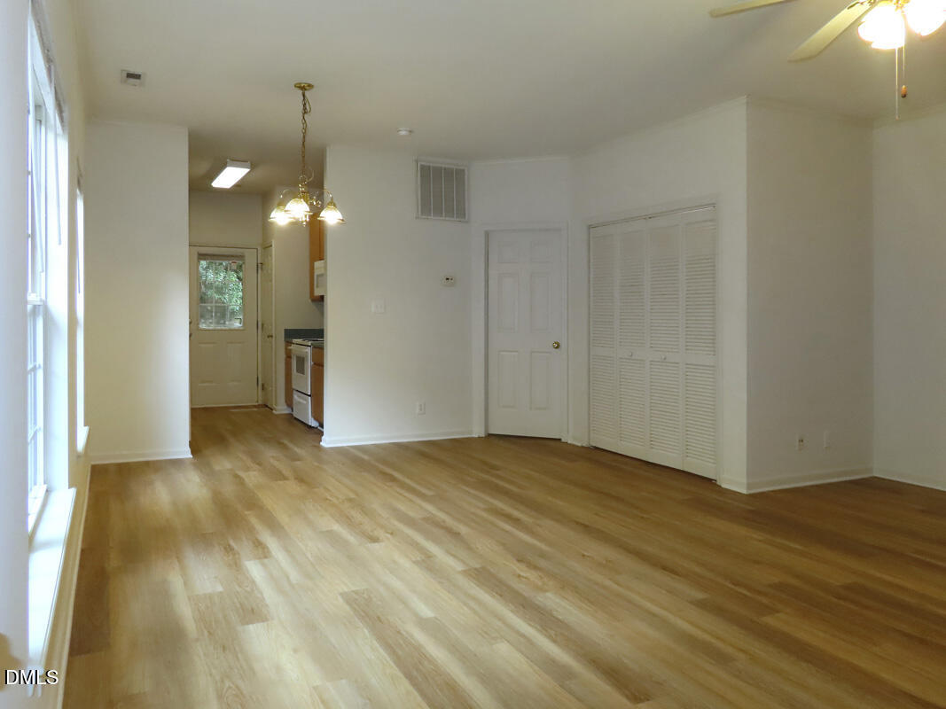 101 Rock Haven Road, Unit E500 Carrboro, NC 27510 - Photo 2 of 19 a view of empty room with wooden floor