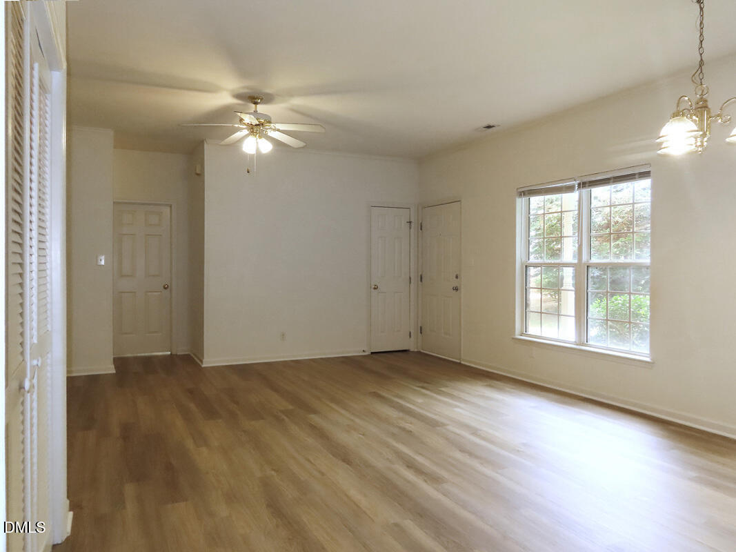 101 Rock Haven Road, Unit E500 Carrboro, NC 27510 - Photo 3 of 19 an empty room with wooden floor fan and windows