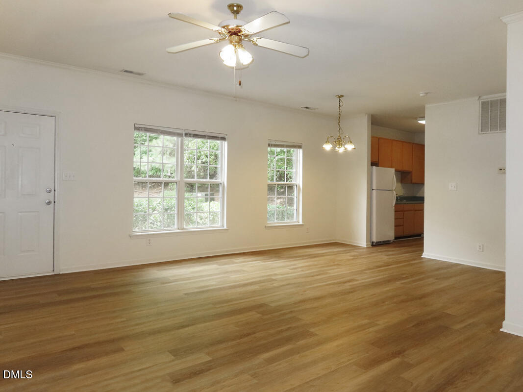 101 Rock Haven Road, Unit E500 Carrboro, NC 27510 - Photo 4 of 19 a view of an empty room with window and wooden floor