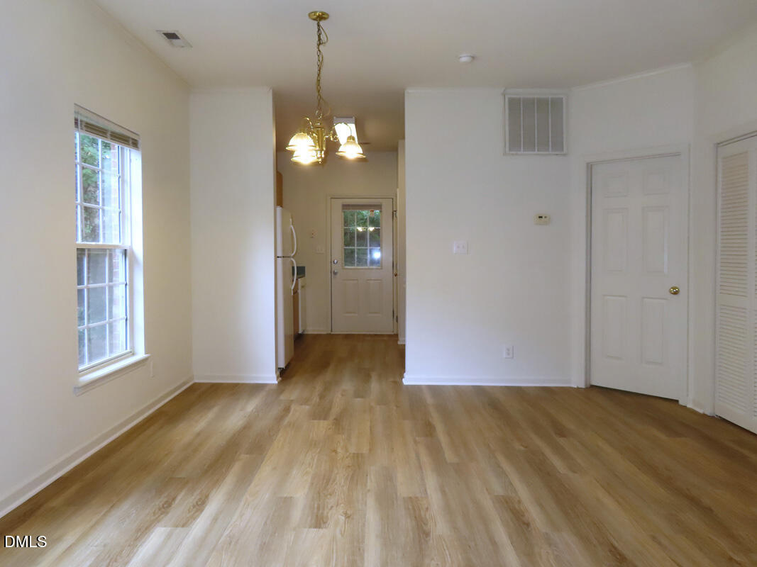 101 Rock Haven Road, Unit E500 Carrboro, NC 27510 - Photo 6 of 19 a view of empty room with wooden floor and fan