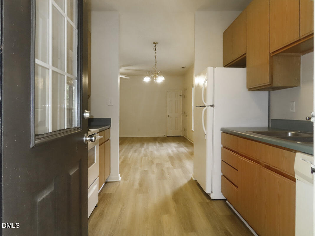 101 Rock Haven Road, Unit E500 Carrboro, NC 27510 - Photo 8 of 19 a kitchen with a refrigerator and a stove top oven