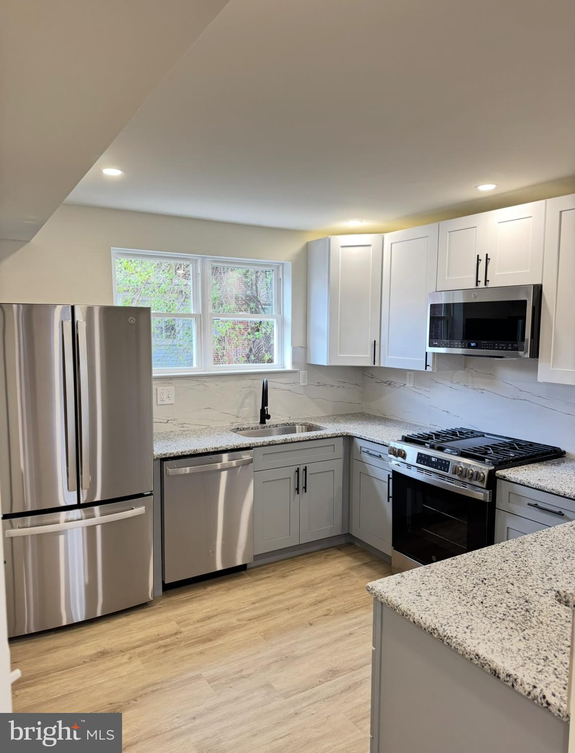 7816 Temple Road Philadelphia, PA 19150 - Photo 4 of 24 a kitchen with stainless steel appliances granite countertop a refrigerator sink stove microwave and cabinets