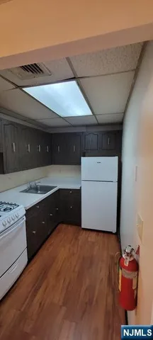 a kitchen with granite countertop a refrigerator and a stove