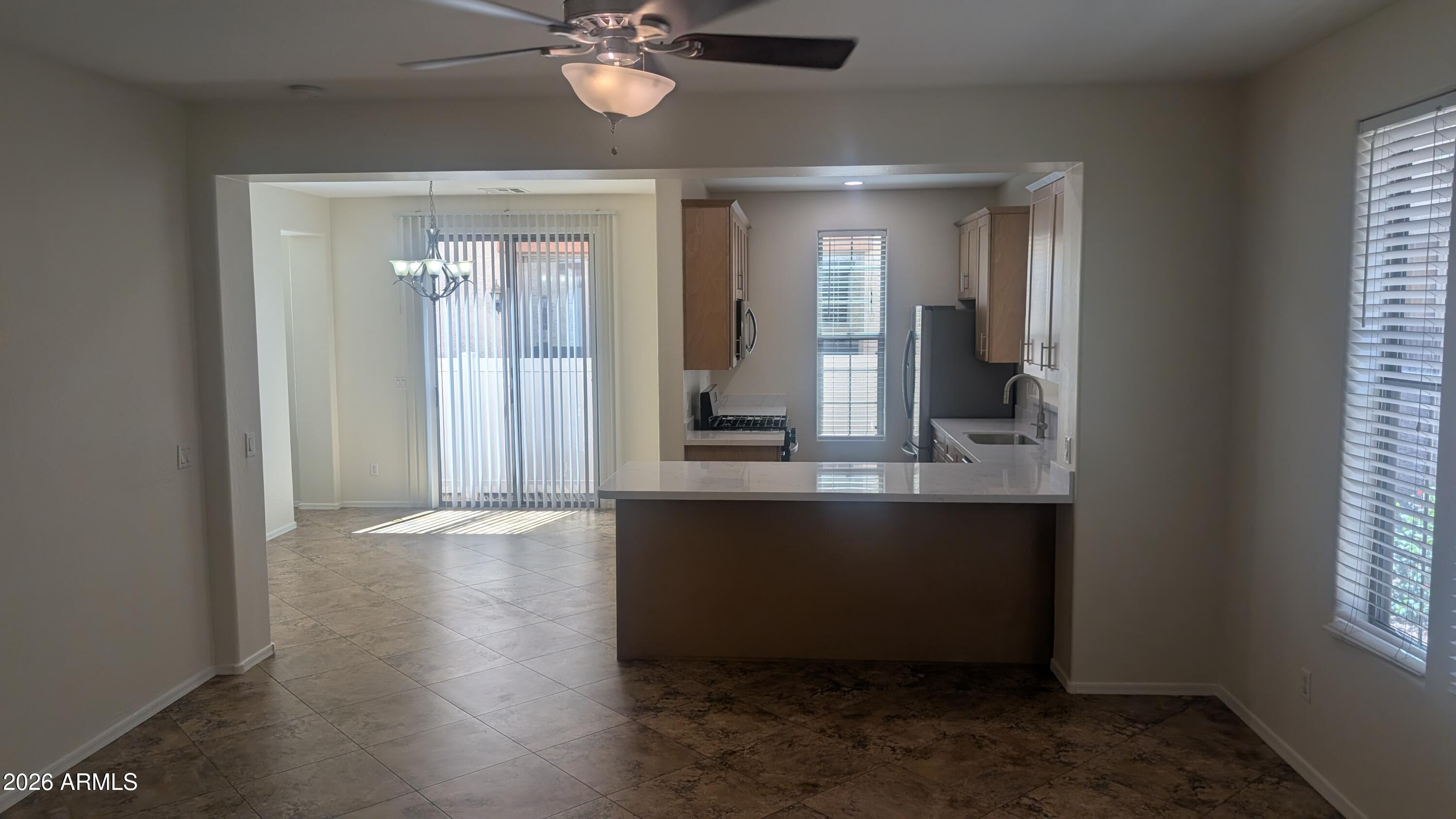 1453 South Sinova Avenue Gilbert, AZ 85296 - Photo 15 of 46 an empty room with wooden floor and windows