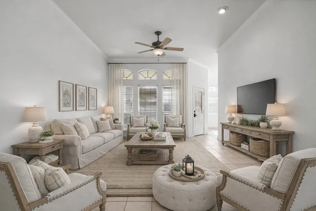 a living room with furniture fireplace and a large window