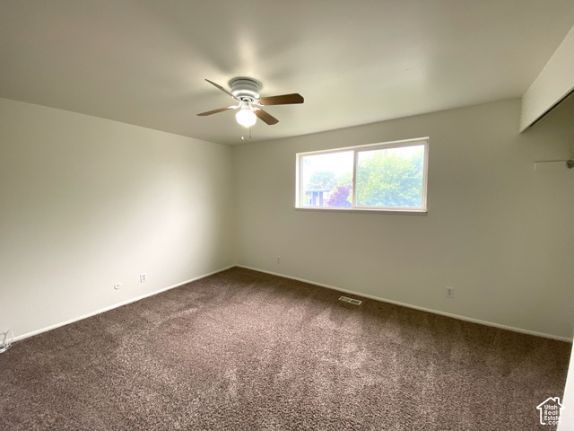 2989 Rae Street West Valley City, UT 84120 - Photo 14 of 25 Neutral-toned walls complement the brown carpet flooring
