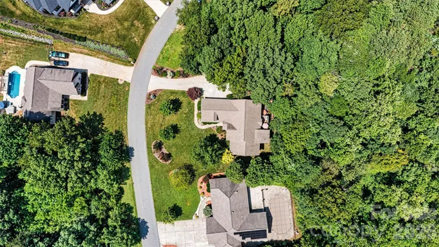 an aerial view of a house with a yard and plants