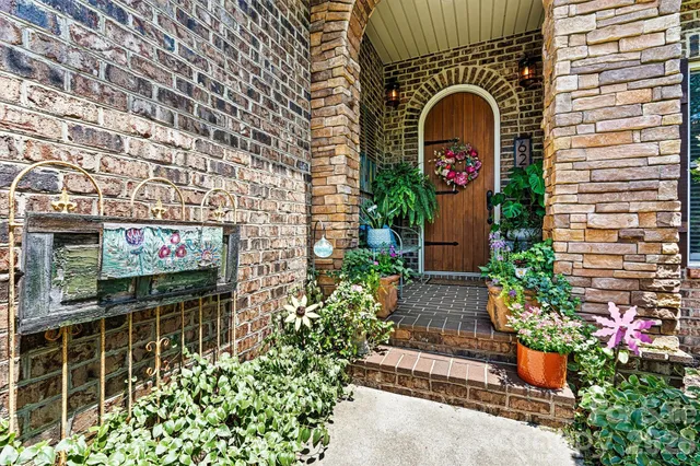 a front view of a house with plants