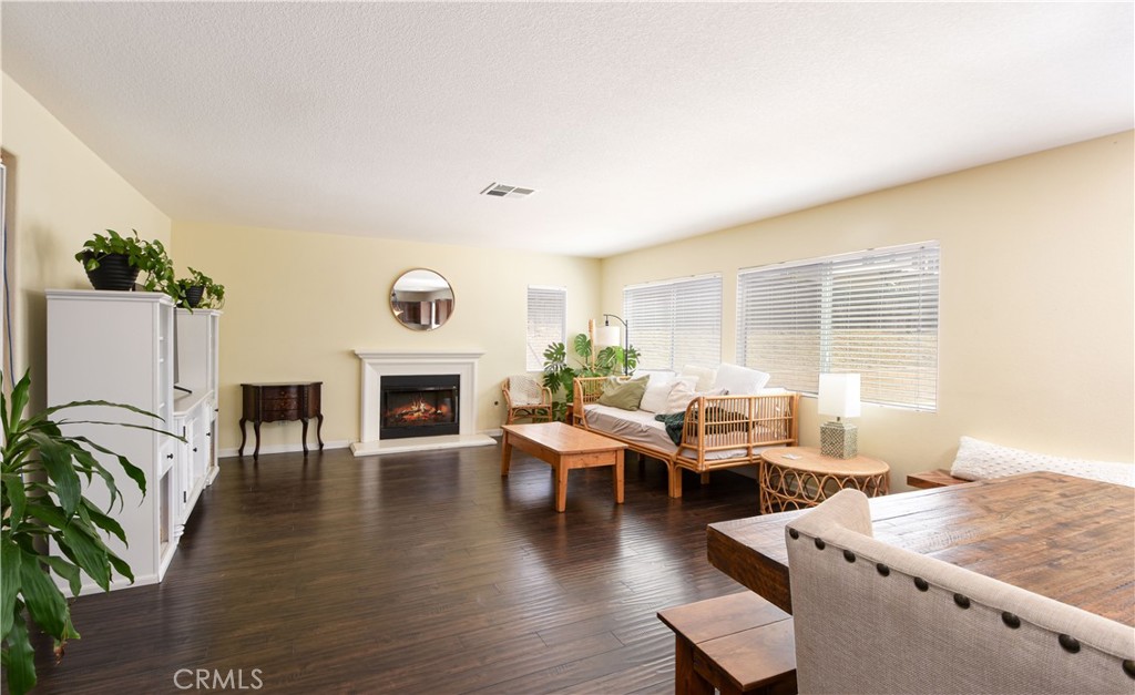 35630 Bryce Road Winchester, CA 92596 - Photo 5 of 32 a living room with fireplace furniture and a wooden floor