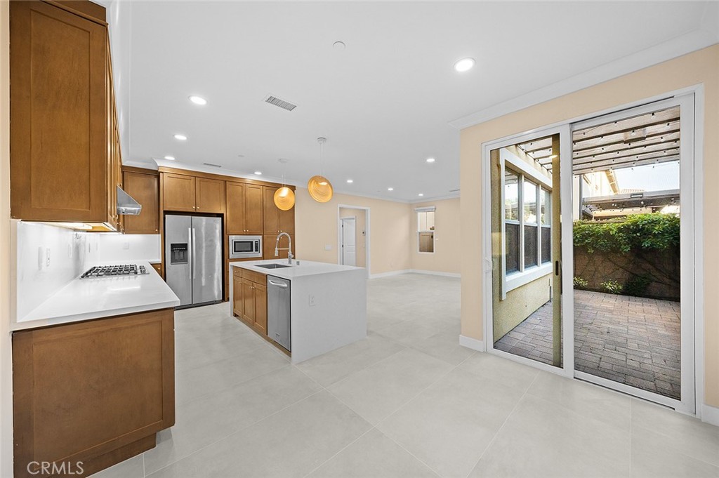 143 Rodeo Irvine, CA 92602 - Photo 12 of 37 a large kitchen with a large counter top a stove a sink and a refrigerator