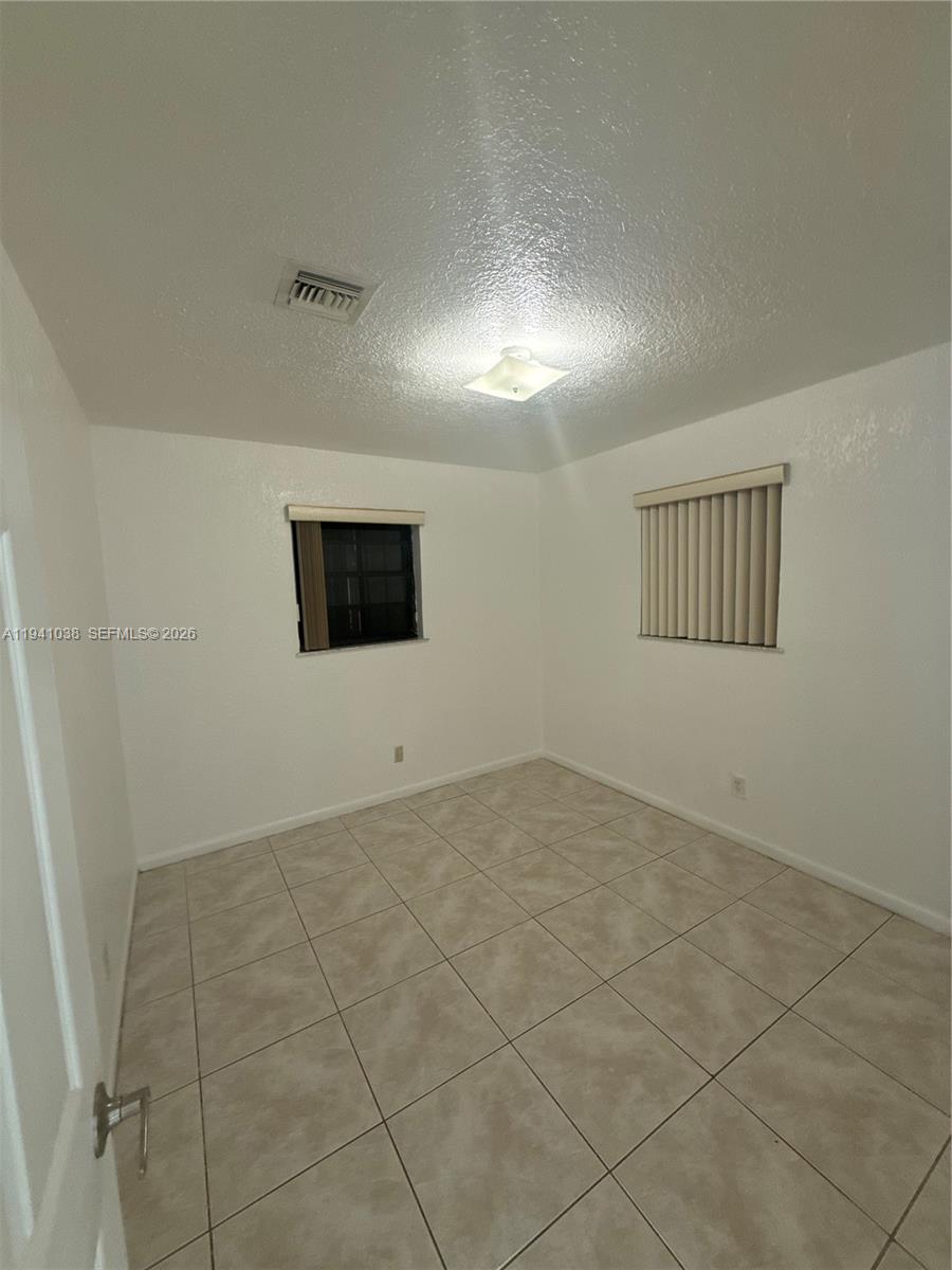 10335 Southwest 181st Street, Unit 2 Miami, FL 33157 - Photo 4 of 7 a view of an empty room with windows