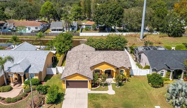 an aerial view of a house with swimming pool and outdoor seating