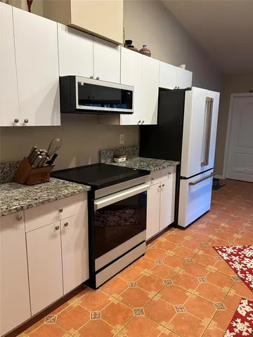 a bedroom with a bed and a night stand