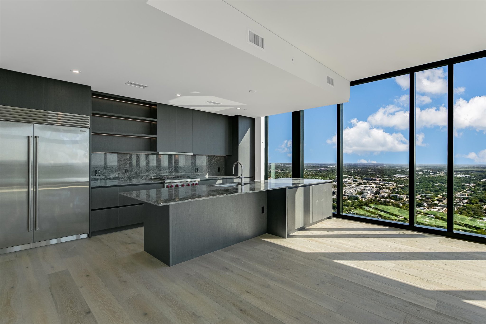 610 Davis Street, Unit 4501 Austin, TX 78701 - Photo 5 of 33 a kitchen with stainless steel appliances granite countertop a refrigerator and a sink