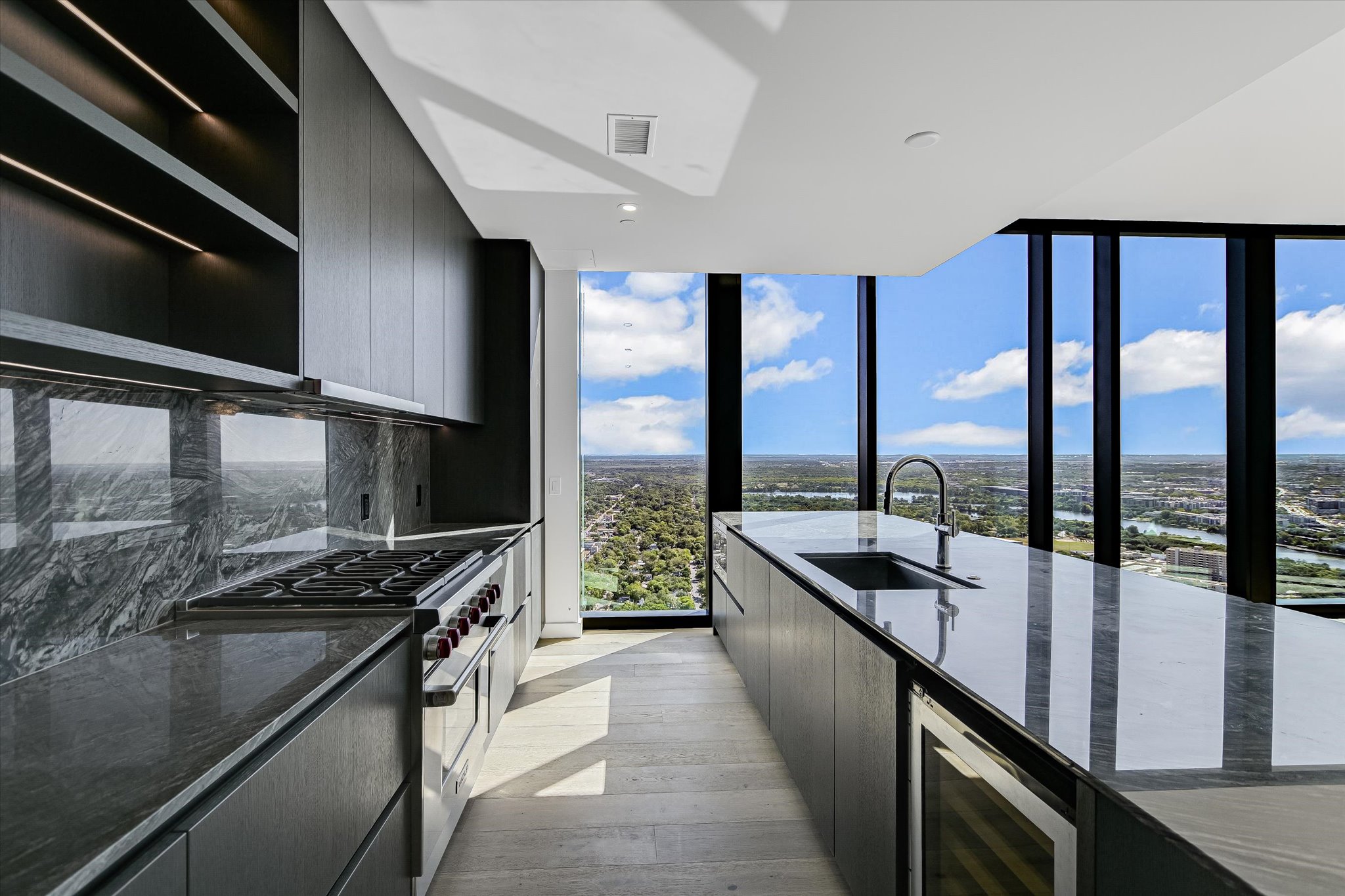 610 Davis Street, Unit 4501 Austin, TX 78701 - Photo 6 of 33 a kitchen with stainless steel appliances granite countertop a sink and a stove
