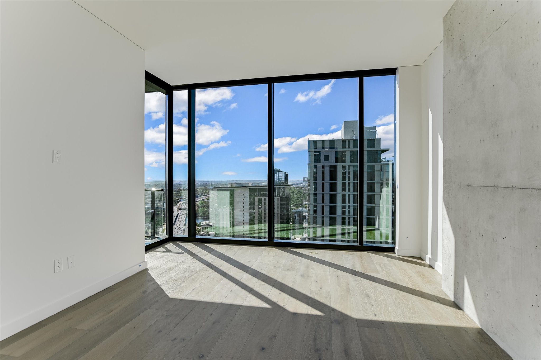 610 Davis Street, Unit 4501 Austin, TX 78701 - Photo 8 of 33 a view of a room with wooden floor and windows
