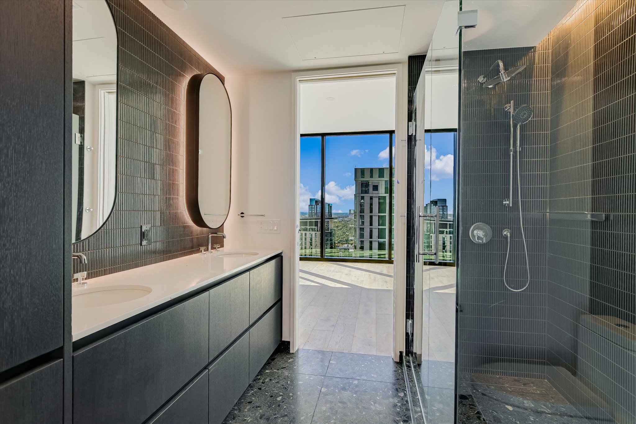 610 Davis Street, Unit 4501 Austin, TX 78701 - Photo 9 of 33 a bathroom with a mirror sink vanity and tub