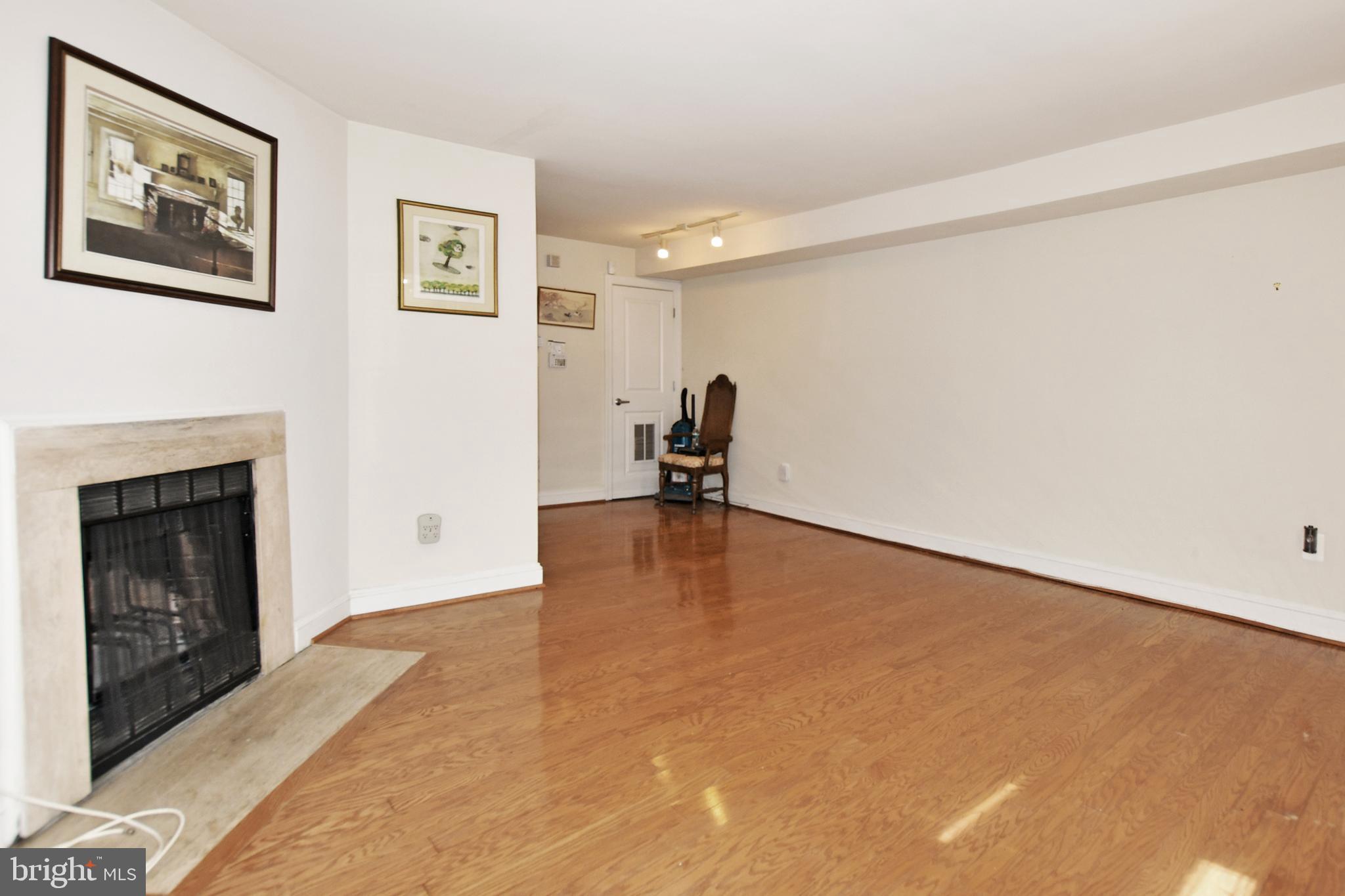 35 14th Street Northeast, Unit 35 Washington, DC 20003 - Photo 12 of 27 a view of empty room with a fireplace and wooden floor
