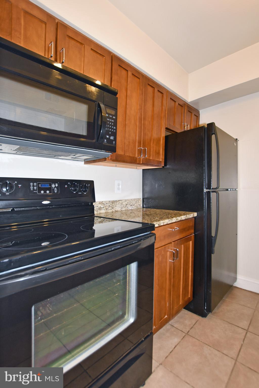 35 14th Street Northeast, Unit 35 Washington, DC 20003 - Photo 18 of 27 a kitchen with stainless steel appliances granite countertop a refrigerator and a microwave