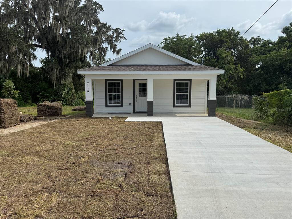 a front view of a house with yard and green space