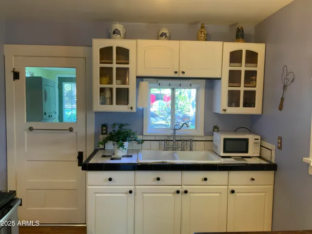 a kitchen with a sink and a window
