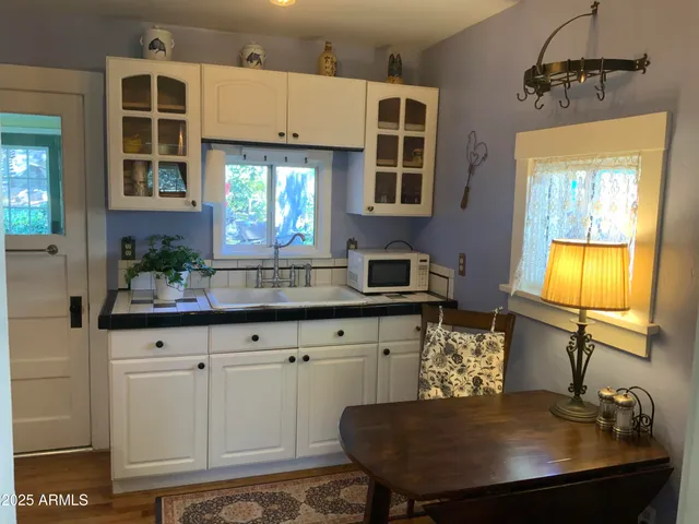 a kitchen with a sink cabinets and window