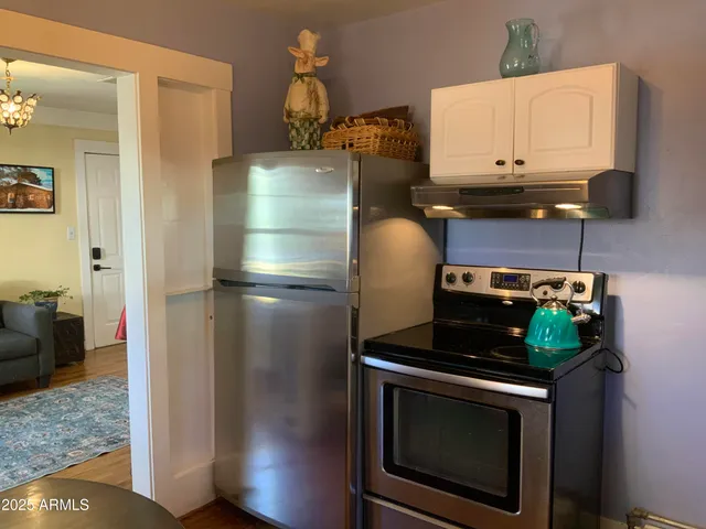 a kitchen with a stove and a refrigerator