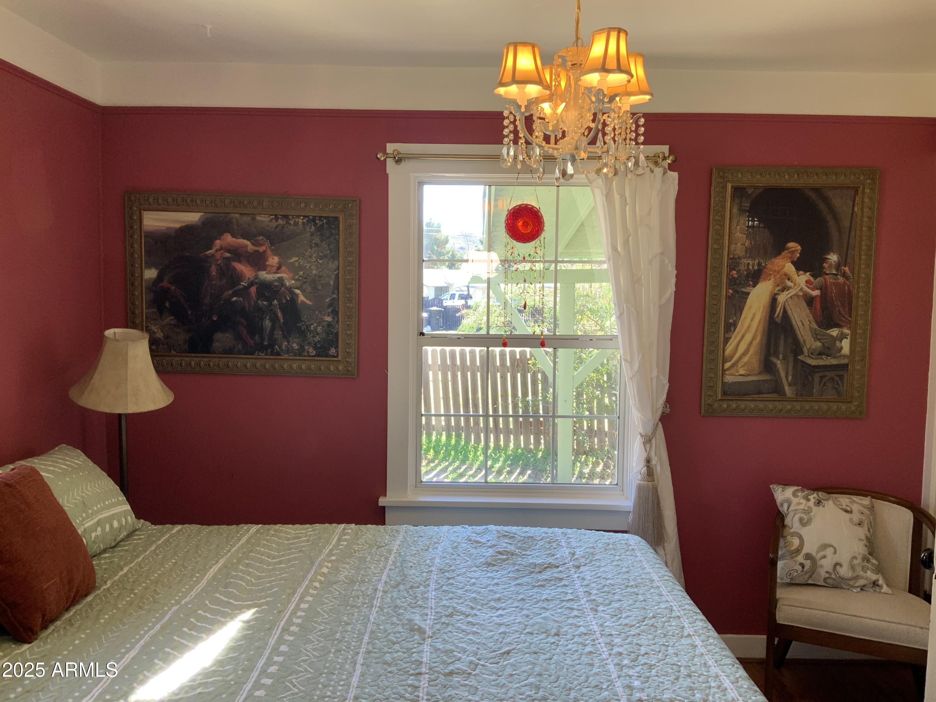 16775 Shrine Drive Yarnell, AZ 85362 - Photo 21 of 46 a bedroom with a bed and a chandelier