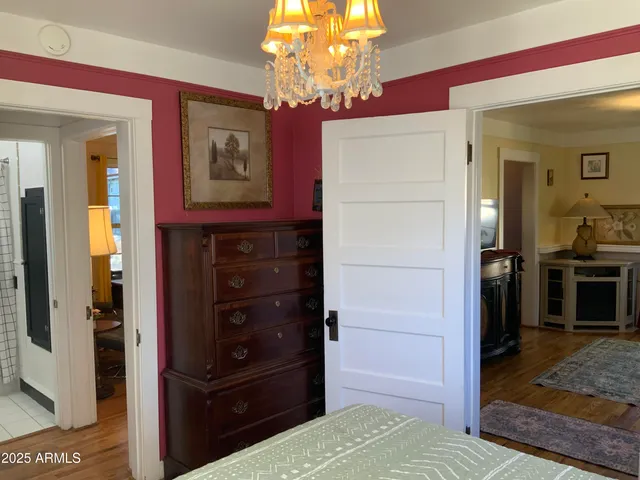 a view of a hallway and cabinet with mirror