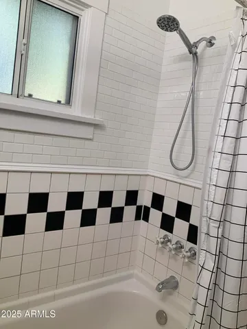 a bathroom with a black white checkered floor and white checkered floor