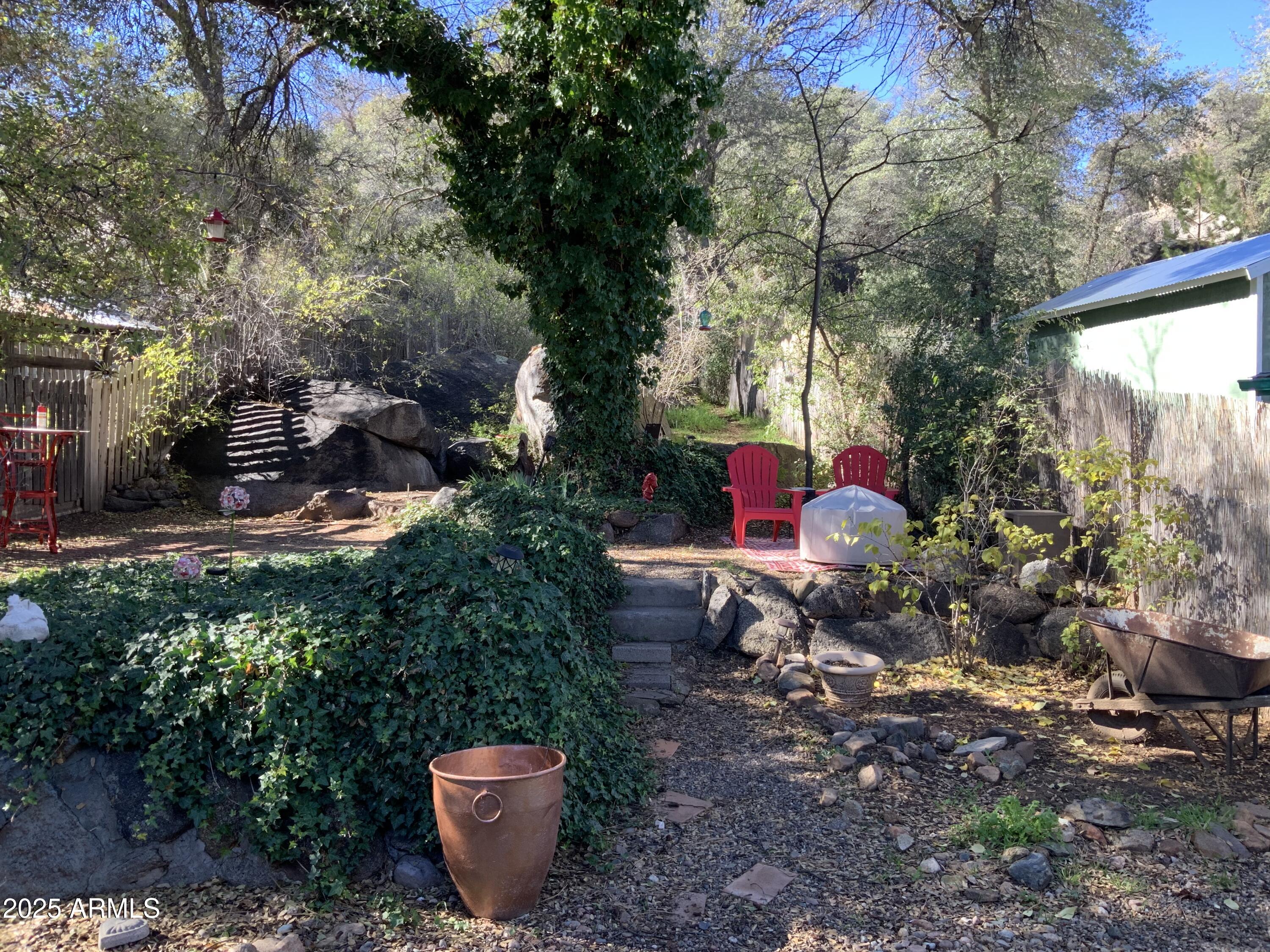 16775 Shrine Drive Yarnell, AZ 85362 - Photo 32 of 46 a view of a backyard with table and chairs and a fire pit