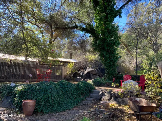 a backyard of a house with a yard and outdoor seating