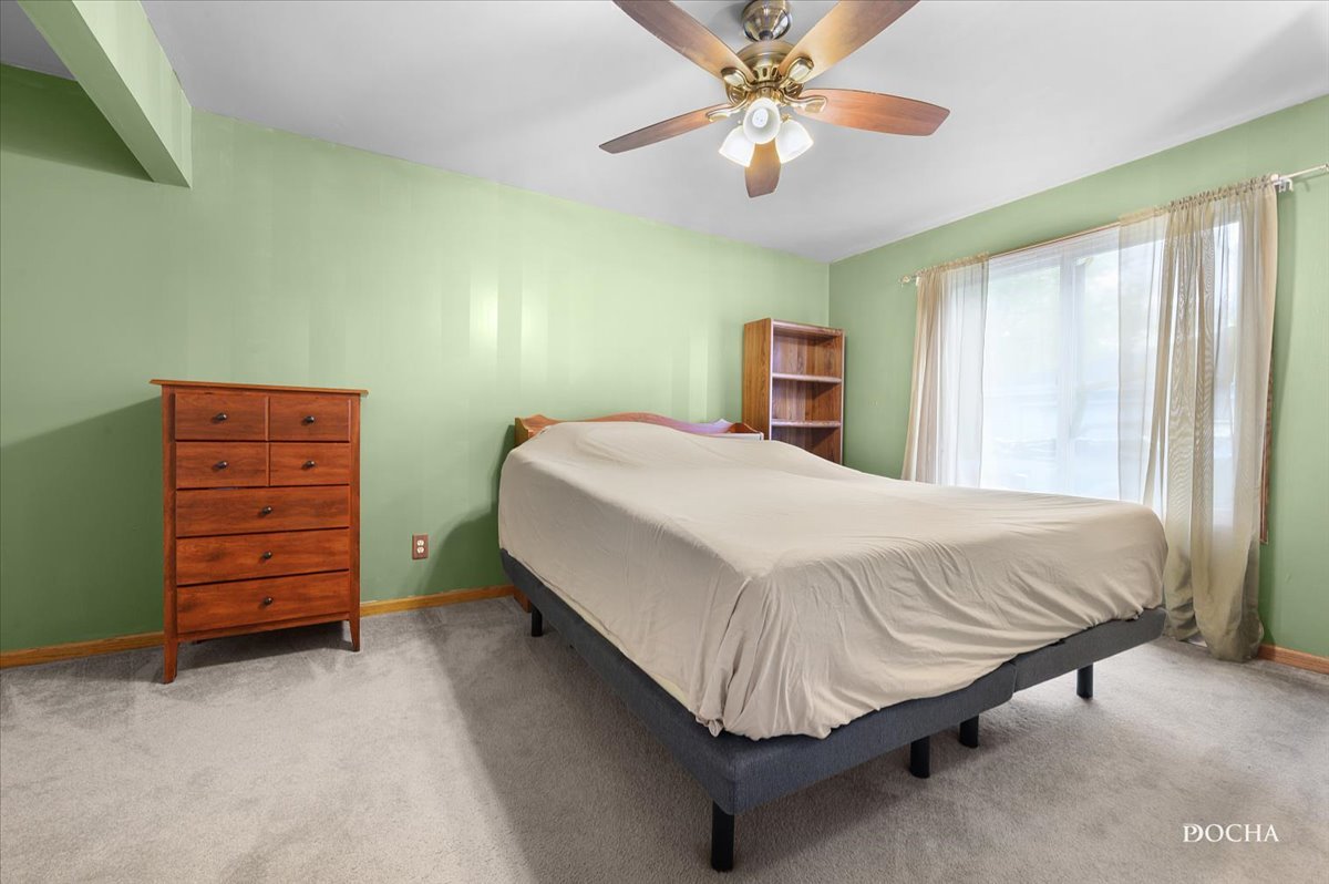 38 Pembrooke Road Montgomery, IL 60538 - Photo 8 of 16 a bedroom with a bed and a chandelier
