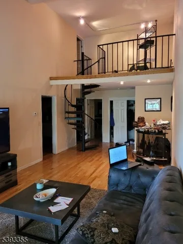 a living room with furniture and a dining table with kitchen view